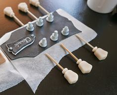 there are many marshmallows on top of the guitar shaped candy bar wrapper