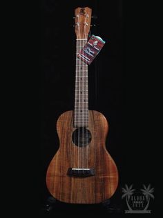 the ukulele is made out of wood and has a guitar string attached to it