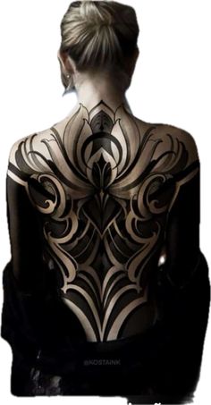 the back of a woman's body is shown in black and white, with intricate designs on it