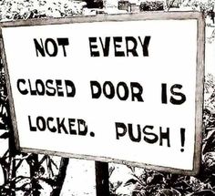 a black and white sign that says not every closed door is locked push on it