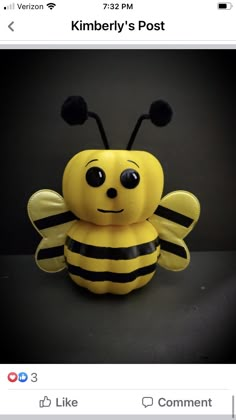 a stuffed bee sitting on top of a table next to a black background with the caption kimbery's post