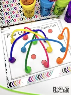 an image of some colorful play doughs on a table with markers and paint tubes