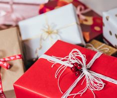 presents wrapped in red paper and tied with twine, sitting next to each other