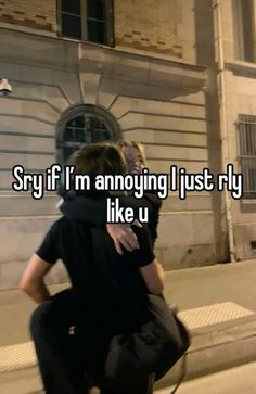 two people hugging each other while sitting on a bench in front of a building with the words say if i'm annoying i just fly like u