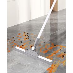 a mop is laying on the floor with orange spots