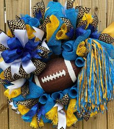 a football wreath with blue, yellow and white streamers