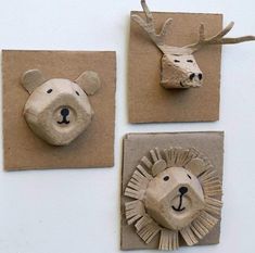 three paper mache animals are on display in the shape of heads and faces,