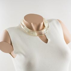 This is part of Chairish’s Costume Jewelry assortment.  An elegant Italian artisan designer studio collar choker necklace.  Lucite or resin rigid bib shape in translucent clear color ornate with silver flakes inclusions in an organic abstract free-form design. Silvered metal chain to adjust the length. No visible maker's mark. Measurements: The inner circumference is 16.57 in (42 cm) - the front height is 1 in (2.6 cm) - the opening is 3.38 in (8.5 cm) - the necklace will fit an average 14.57 in Elegant Resin Necklaces For Party, Formal Clear Lucite Jewelry, White Resin Necklaces, Elegant Clear Resin Jewelry, Elegant White Resin Necklace, Modern White Lucite Jewelry, Elegant Lucite Jewelry For Formal Occasions, Elegant White Resin Jewelry, Adjustable Elegant Resin Necklace