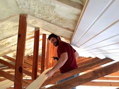 a man standing on top of a wooden floor next to a white wall and ceiling