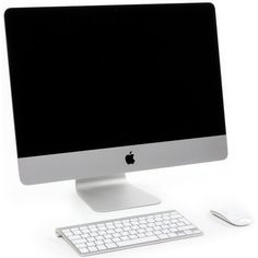 an apple desktop computer sitting on top of a white desk next to a mouse and keyboard