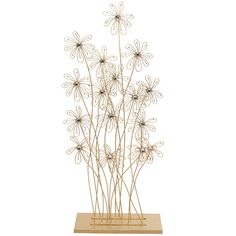 a metal flower sculpture on a wooden base