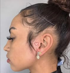 a close up of a person with ear piercings on their ears and wearing a black shirt