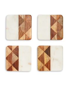 four wooden coasters with white and brown designs on the top one is made out of wood