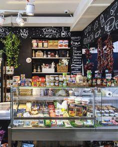 the inside of a deli filled with lots of food and condiments on display