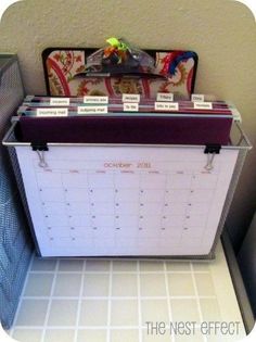 a desk calendar sitting on top of a metal bin