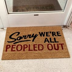 a door mat that says sorry we're all people out on the front porch