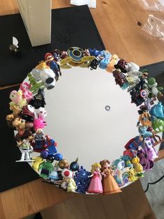 there is a mirror that has many different toys on the top and bottom of it