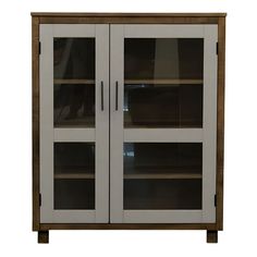 a white cabinet with two glass doors on the top and bottom shelves in front of it