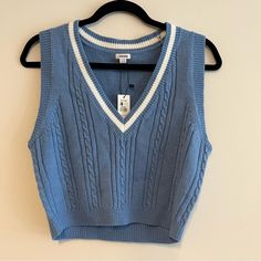 Little Cropped, Baby Blue Mini Sweater Vest From Garage. Cable Knit, And V-Neck With A White Stripe Around The Neckline. Brand New With Tags! All Measurements Are Approximate And Taken With The Item Laid Flat. Chest: 16" Hips: 14" Length: 18" Sleeve: 3.5" Waist: 15" Affordable Blue V-neck Vest, Blue Cotton Sweater Vest For Fall, Blue Sleeveless Sweater For Spring, Light Blue Cotton V-neck Sweater, Blue Sleeveless Casual Sweater, Light Blue V-neck Cotton Sweater, Blue Knit Sweater Vest For Spring, Trendy Blue Sleeveless Sweater, Trendy Sleeveless Blue Sweater