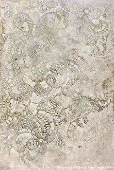 an old paper with lace on it and some flowers in the middle, as seen from above