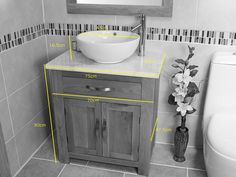 a bathroom with a sink, toilet and mirror measurements for the size of the vanity