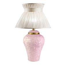 a pink lamp with a white shade on it's base and a gold trim around the top