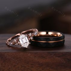 two wedding rings sitting on top of a wooden table next to each other with diamond accents