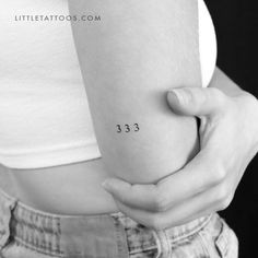 a woman's arm with the number 333 on her left side, in black and white