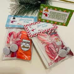 candy canes and candies wrapped in cellophane on a white counter top