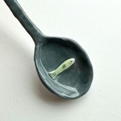 a spoon with a small fish inside of it