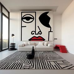 a modern living room with black and white artwork on the wall, couches and rugs