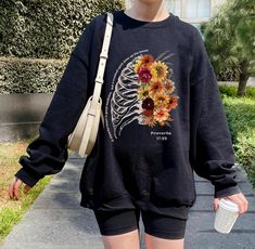 Skeleton Bones and Flowers Sweatshirt features "Proverbs 17:22" and 1/2 Vintage ribs 1/2 Autumn floral arrange on the front and Spine with flowers on the back. Spread the gospel confidently with this gorgeous design fall sweatshirt    HOODIE: https://www.etsy.com/listing/1790818401/halloween-christian-hoodie-skeleton-and?ref=listings_manager_grid T-SHIRT: https://www.etsy.com/listing/1790835397/black-halloween-christian-tshirt?ref=listings_manager_grid THIS SWEATHIRT COMES IN: Black, White, Chocolate, Maroon, Purple GILDAN 18000 SWEATSHIRT 100% COTTON CLASSIC FIT PLEASE SEE SIZING CHART PHOTO PLEASE NOTE THAT THESE SWEATSHIRTS ARE A UNISEX SIZE, MEANING THEY ARE NOT WOMEN'S FITTED SWEATSHIRT. FOR A MORE FITTED LOOK, WE SUGGEST SIZING DOWN. FOR AN OVERSIZED FIT, WE SUGGEST SIZING UP TWO SIZ Spine With Flowers, Bones And Flowers, Halloween Christian, Proverbs 17 22, Hoodie Skeleton, Fall Christian, Floral Skeleton, Spread The Gospel, Proverbs 17