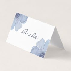 a white table card with blue flowers on it