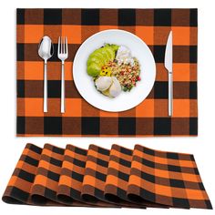 the placemats are orange and black checkered, with silverware next to them