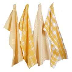 three yellow and white checkered towels hanging on the wall next to each other,