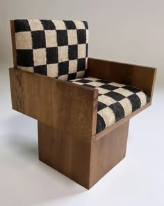 a black and white checkered chair sitting on top of a wooden frame