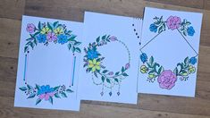 three cards with floral designs on them sitting on a wooden floor next to each other