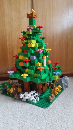 a lego christmas tree with animals around it