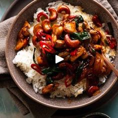 a bowl filled with rice and meat on top of a table