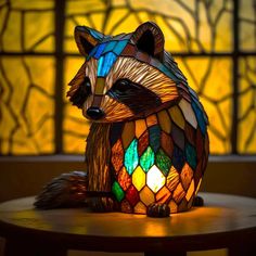 a stained glass raccoon sitting on top of a table