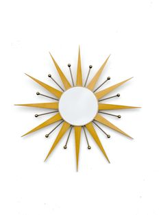 a sunburst shaped mirror is shown against a white background with black pins on it