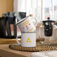 two coffee mugs sitting on top of a counter