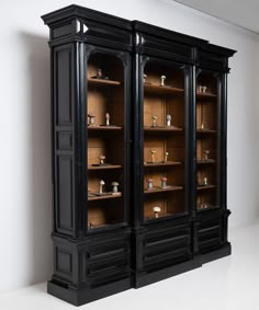 a black bookcase with glass doors and shelves