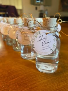 small glass bottles with labels on them sitting on a table