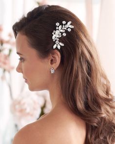 a woman wearing a hair comb with flowers on it