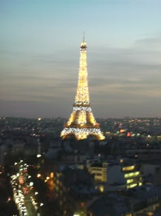 the eiffel tower lit up at night with lights on it's sides