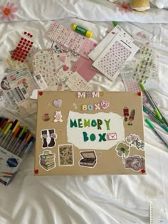 an open memory box surrounded by crafting supplies