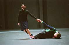 two men in black shirts and blue pants are playing with each other on the floor