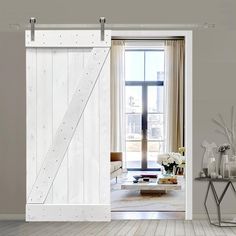 an open white barn door in a living room