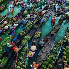 many boats are filled with vegetables and people